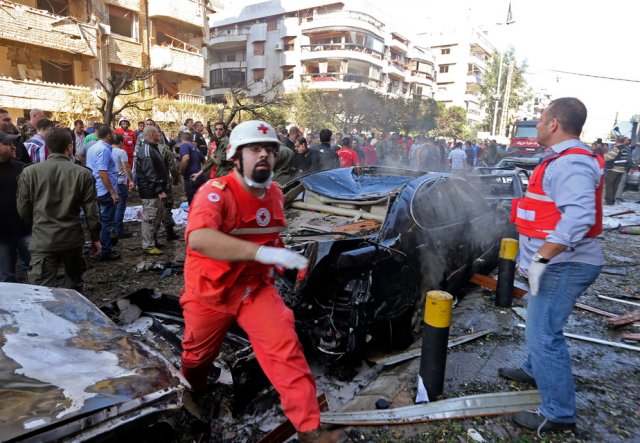 Soldiers, policemen and medical personnel gather at the site of explosions near the Iranian embassy in Beirut